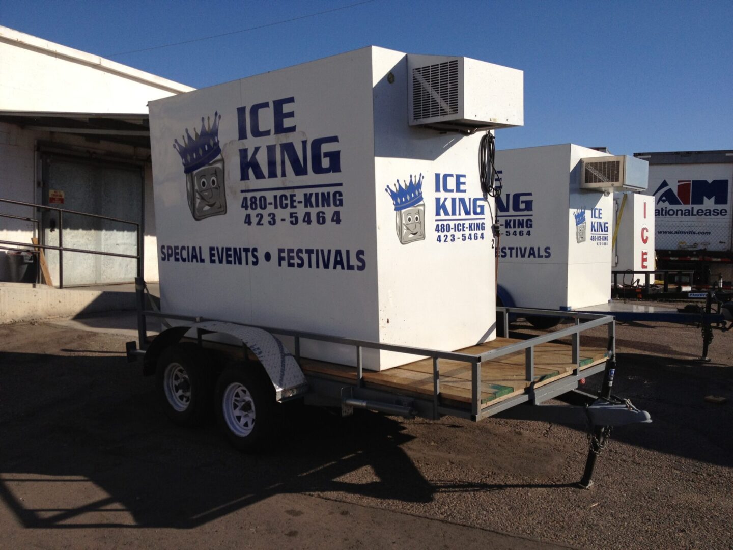 A trailer with two ice machines on it.